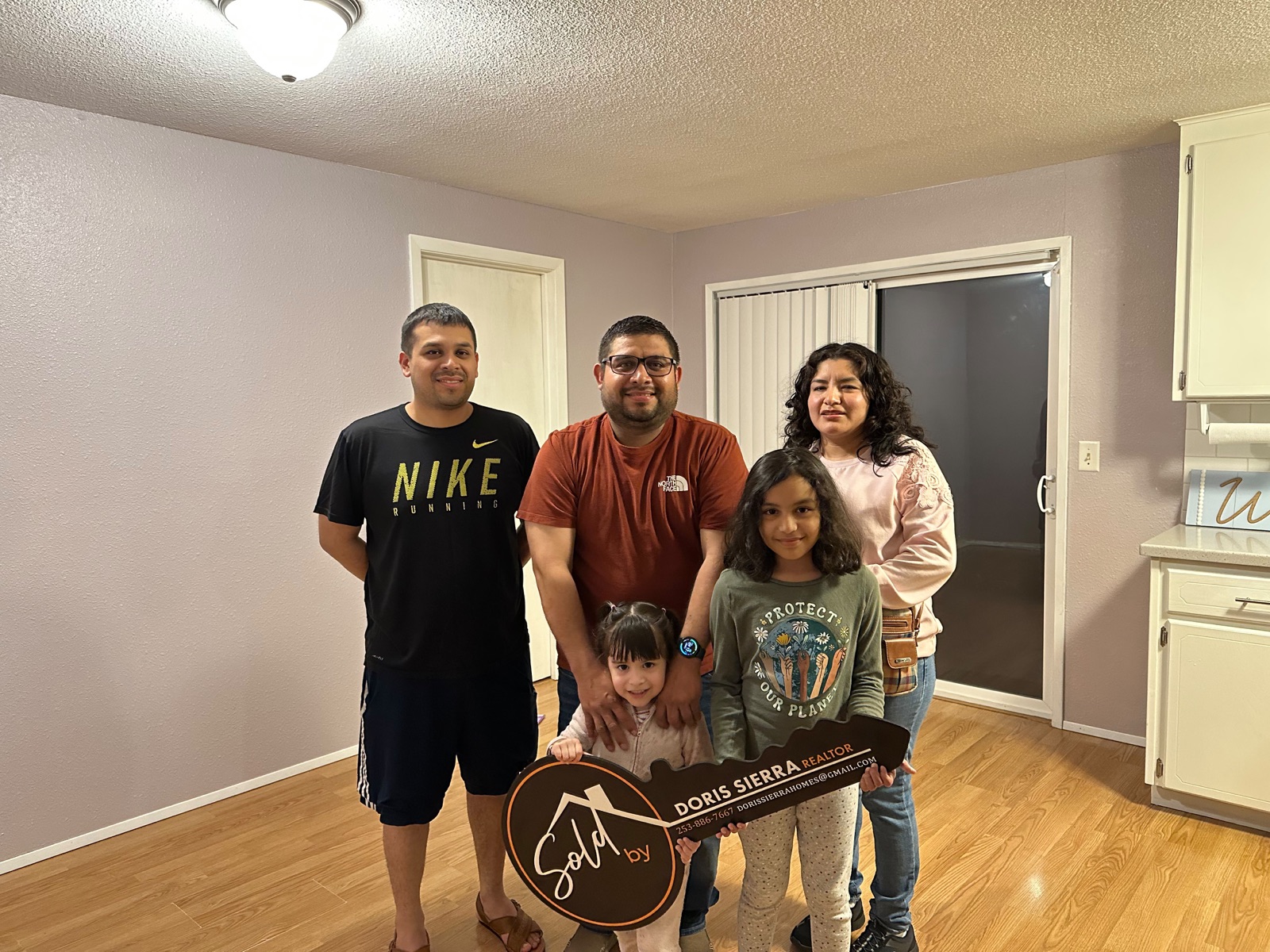 Family with children celebrating in their new home